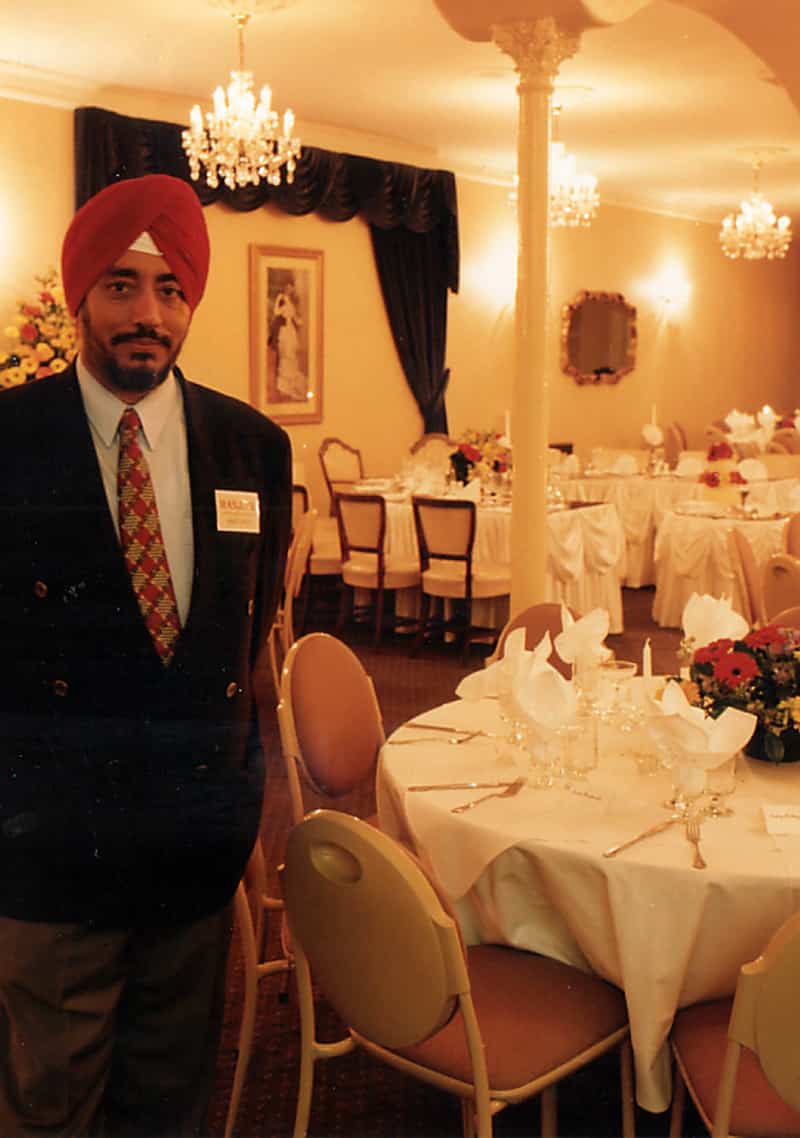 Historic photo from 1984 of Manjit Gujral, founders of Manjits, capturing a moment of their early journey in establishing the renowned restaurant.